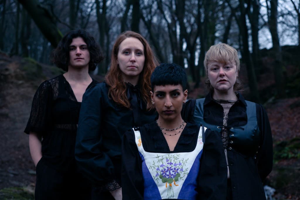 Dogviolet band portrait in a wooded setting.