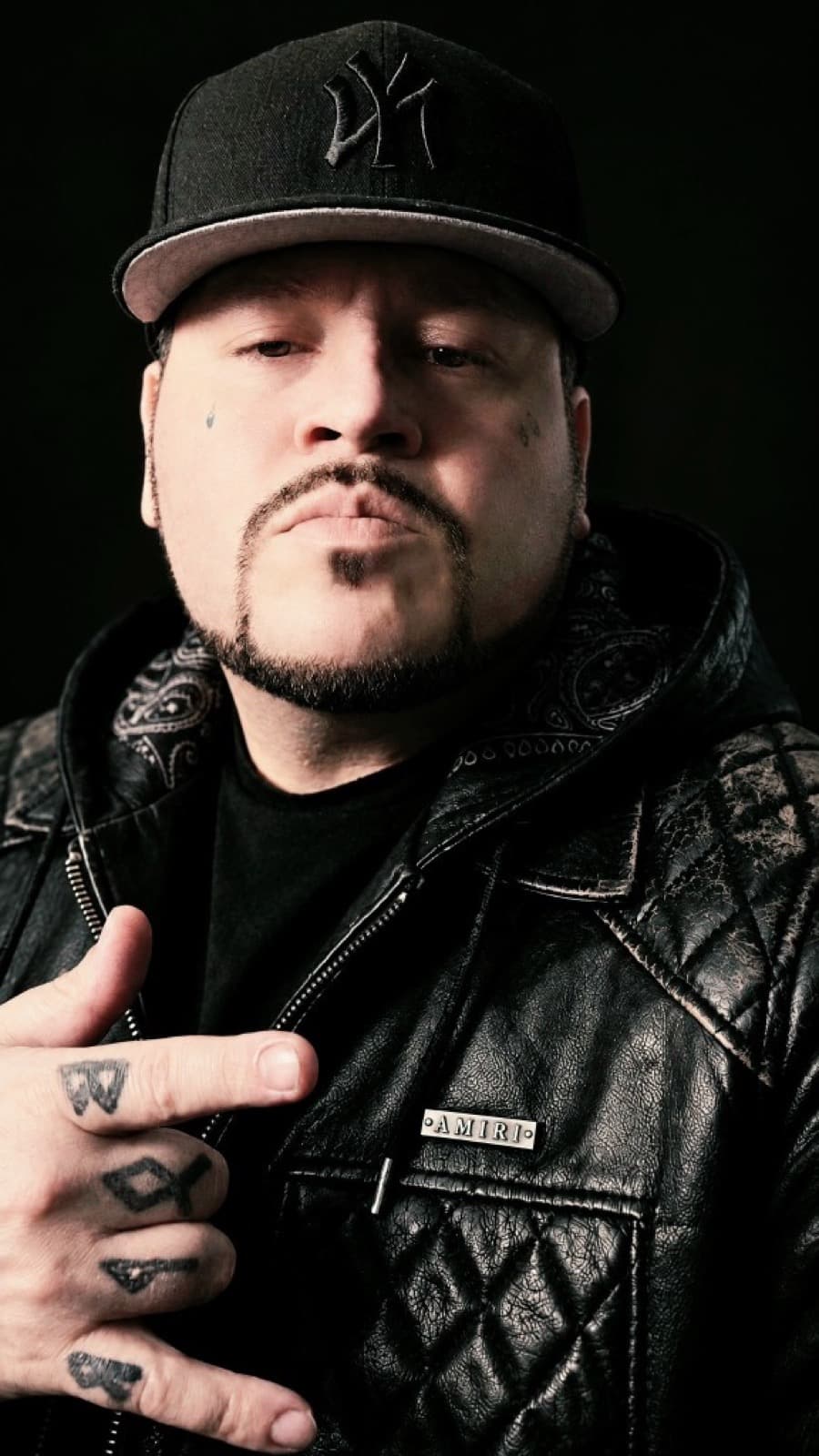 Kold Volk portrait wearing a black Yankees cap and leather jacket.