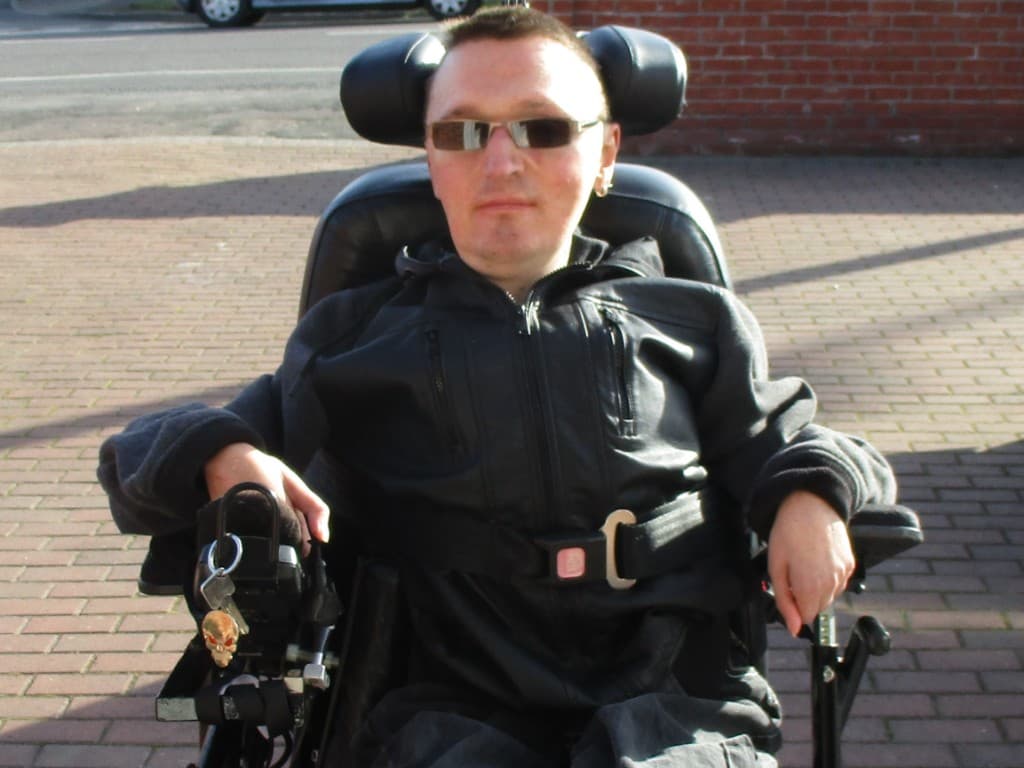 Gavin Moore of Ultra Funkular Sound photographed outdoors, wearing dark sunglasses and a black jacket.